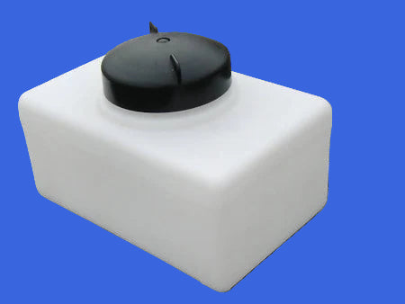 White cube-shaped container with a black lid on a gray surface